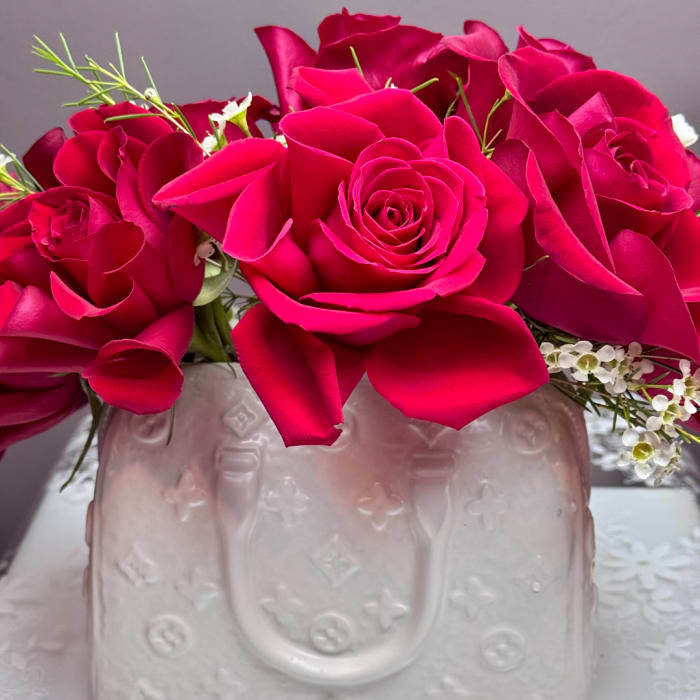 Pink rose bouquet in a pale embossed vase
