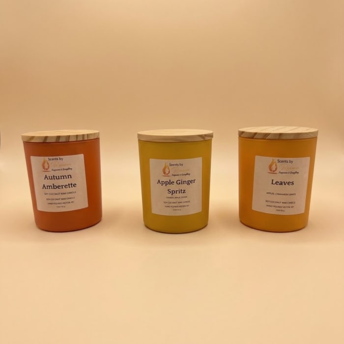 Three scented candles in glass jars with wooden lids
