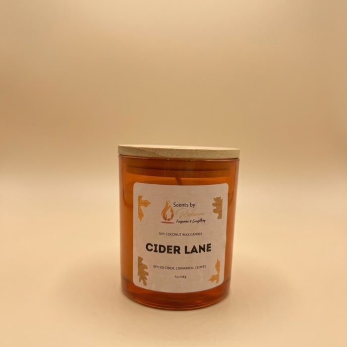 Amber candle in a glass jar with a wooden lid