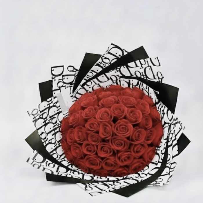 Round bouquet of red roses wrapped in black and white paper