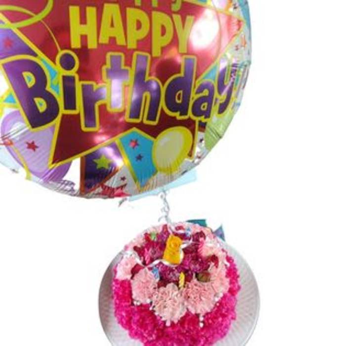 Birthday balloon with a small pink floral arrangement attached below