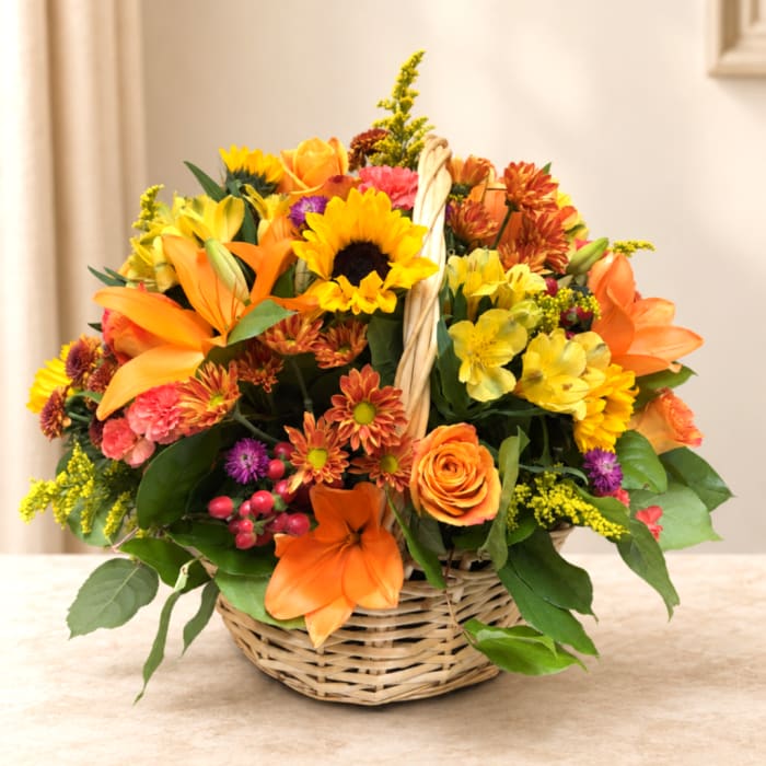 Basket arrangement with sunflowers, lilies, roses, and mixed blooms