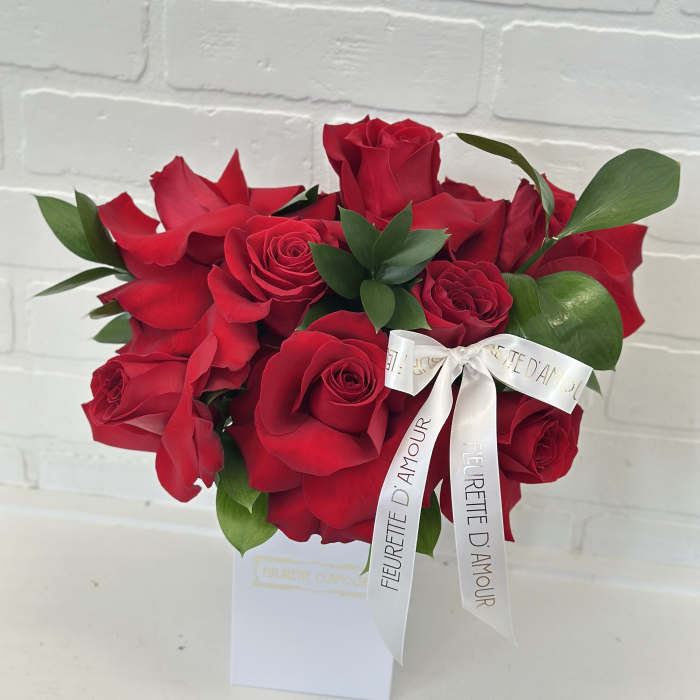 Red rose bouquet with a white ribbon in a white box