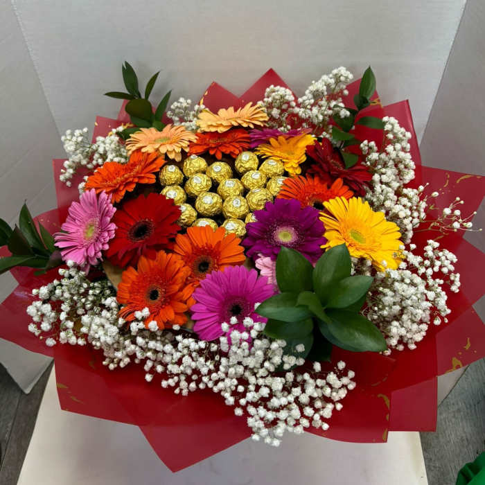 Colorful gerbera daisy bouquet with baby’s breath and gold chocolates