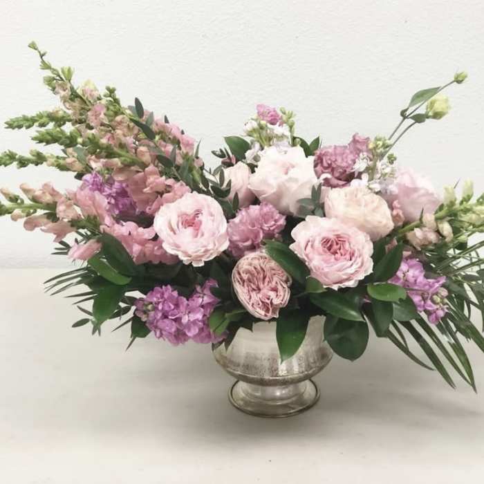 Pink and lavender floral arrangement in a silver vase