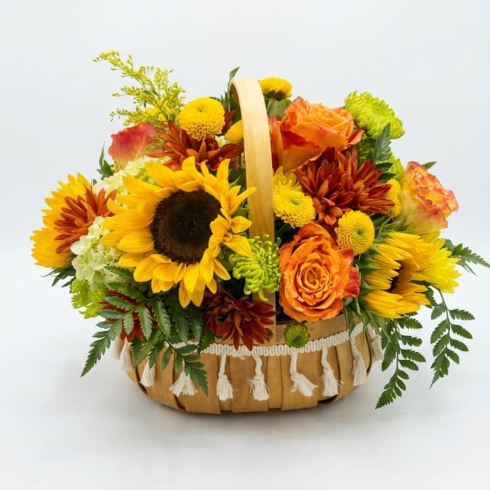 Basket arrangement with sunflowers, orange roses, and chrysanthemums