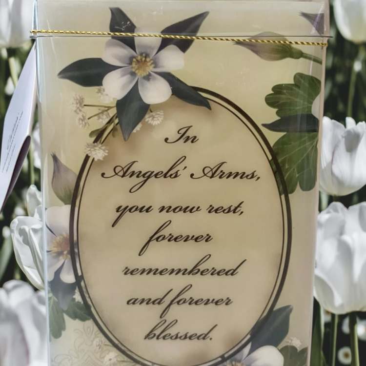 Sympathy card with white flowers and a memorial message