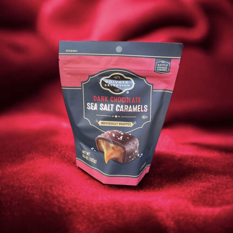 Bag of dark chocolate sea salt caramels on red fabric
