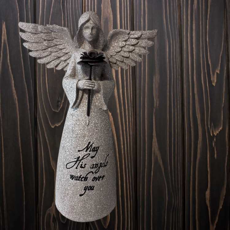 Glittery angel figurine holding a rose with a memorial message