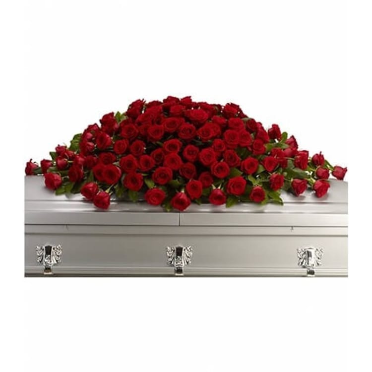 Red rose spray arranged on a silver casket