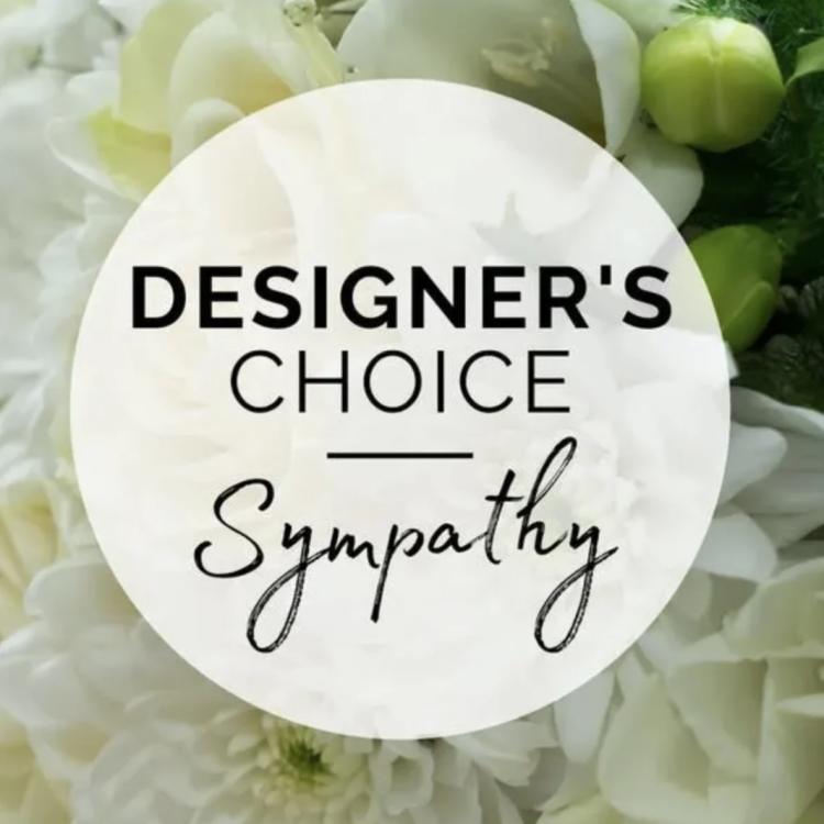 White floral sympathy arrangement with a designer's choice label