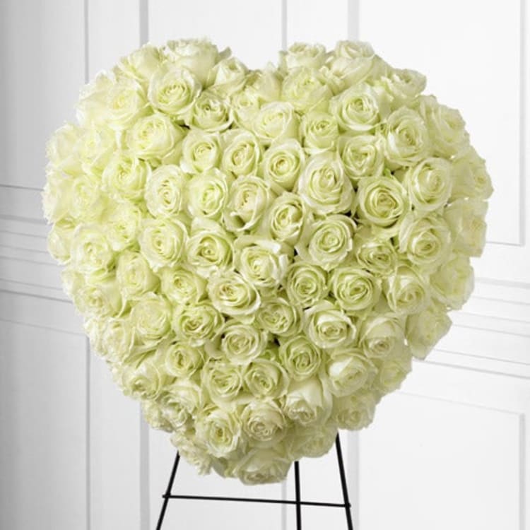 Heart-shaped bouquet of white roses on a stand