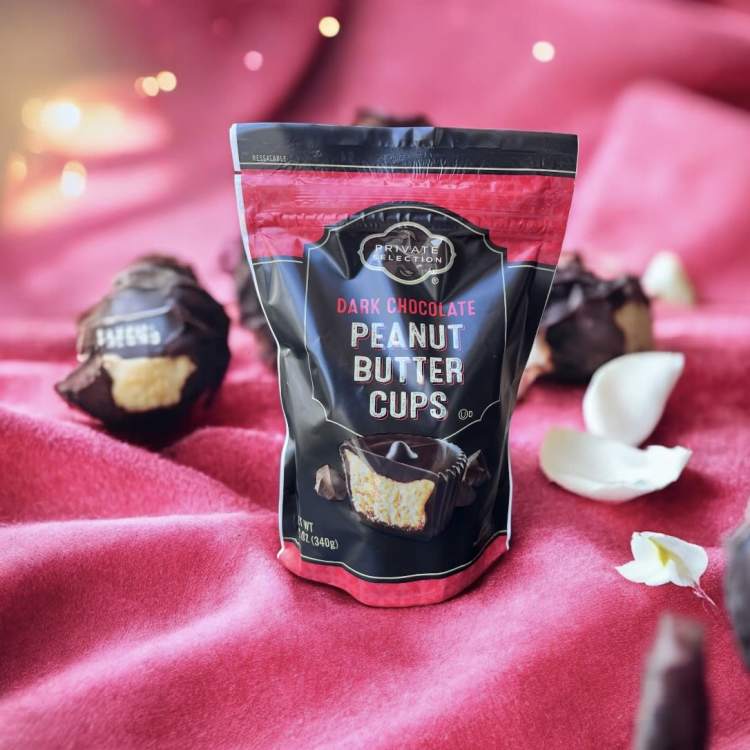 Bag of dark chocolate peanut butter cups on pink fabric