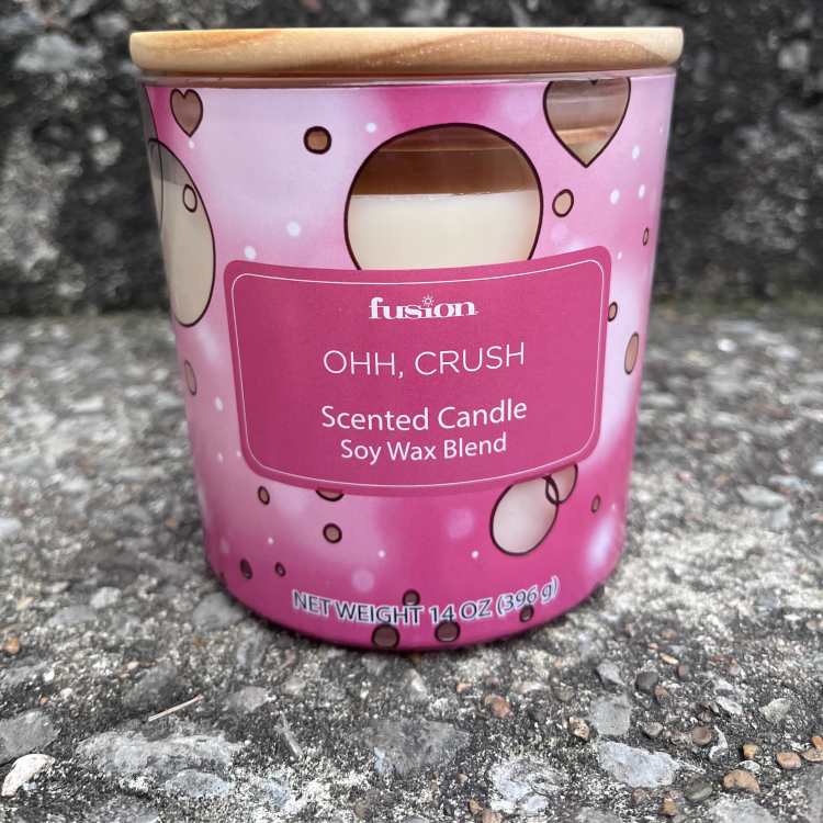 Pink scented candle in a metal tin with a wooden lid