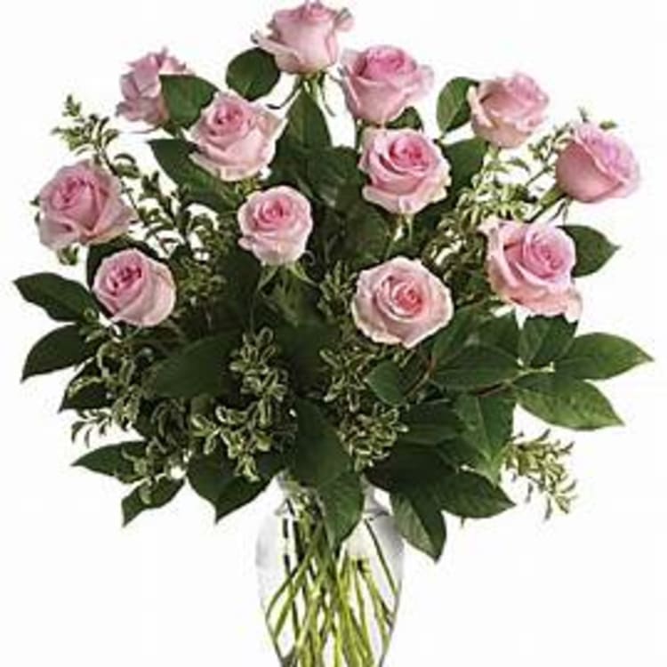 Pink roses arranged in a clear glass vase