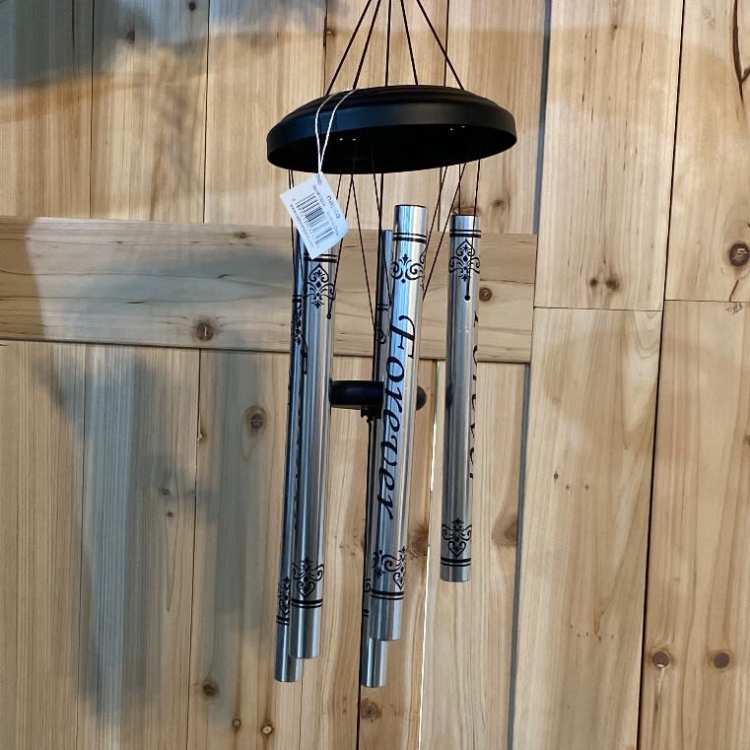 Silver memorial wind chime with a black top and hanging tag