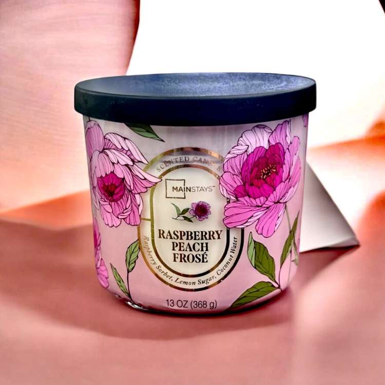 Pink floral scented candle in a black-lidded jar