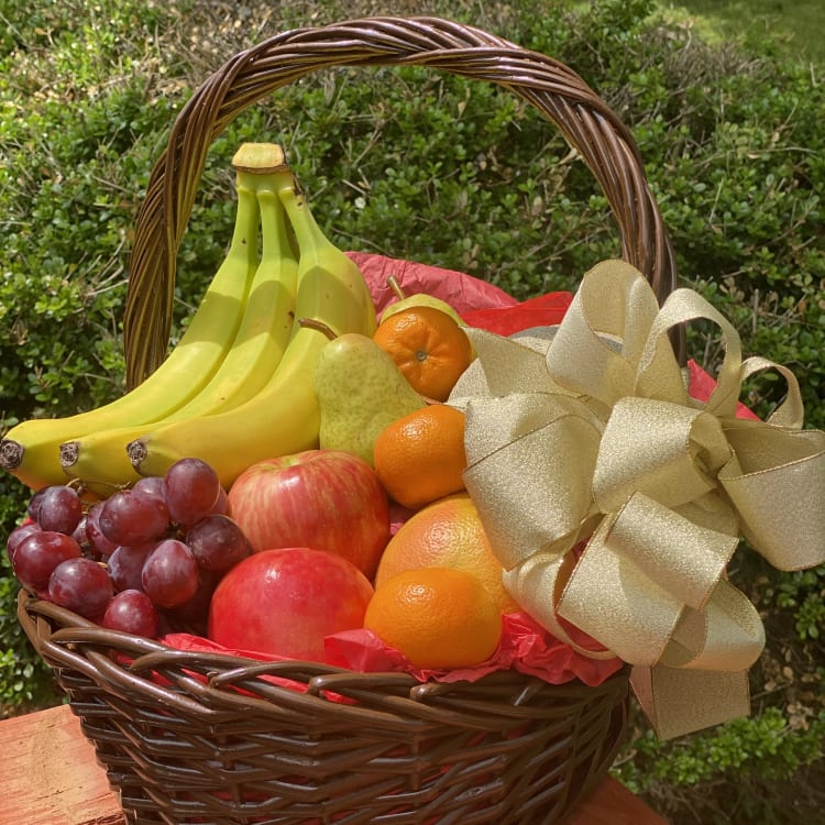 Fruit basket with bananas, grapes, apples, pears, and oranges