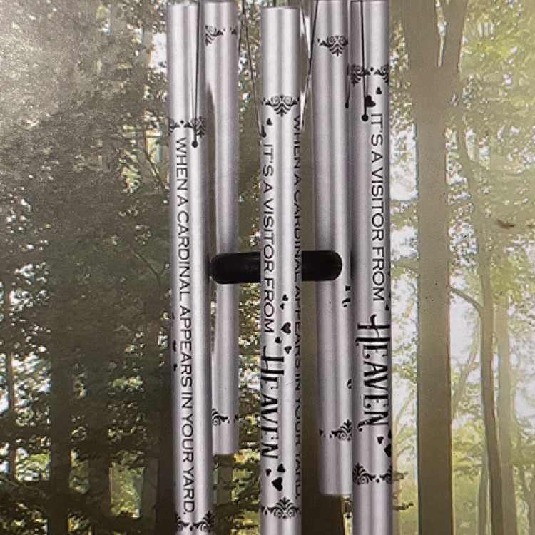 Silver memorial wind chime hanging outdoors