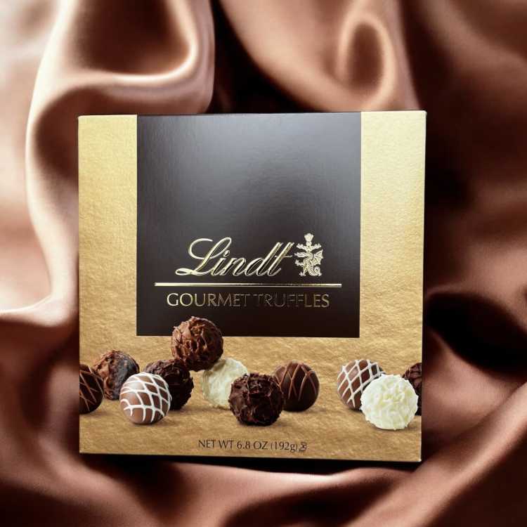Box of Lindt gourmet truffles on a satin background