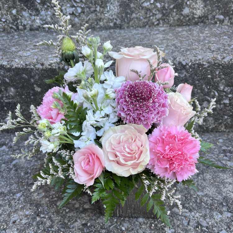 Pink and white rose bouquet with carnations and white filler flowers