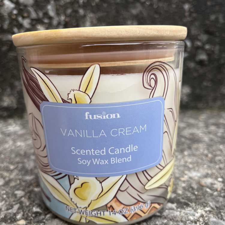 Vanilla cream scented candle in a glass jar with a wooden lid