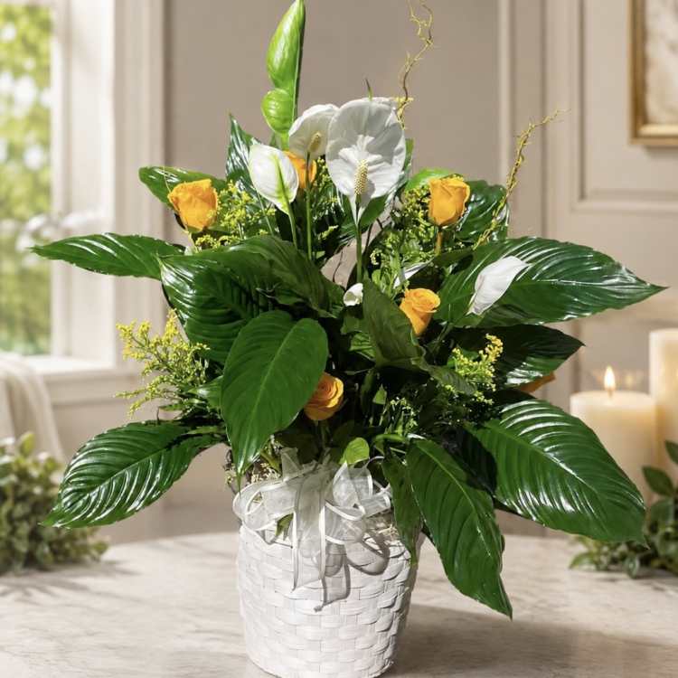 White and yellow floral arrangement in a white basket