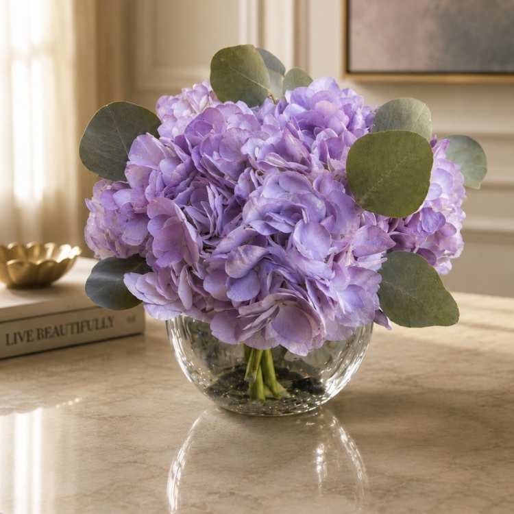 Lavender hydrangea bouquet in a clear glass vase