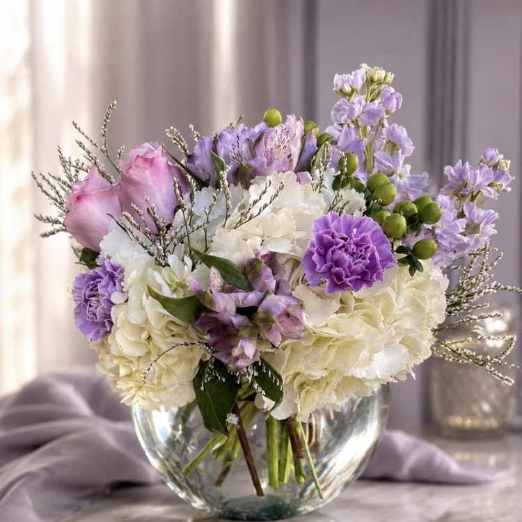 Lavender and white bouquet in a clear glass vase