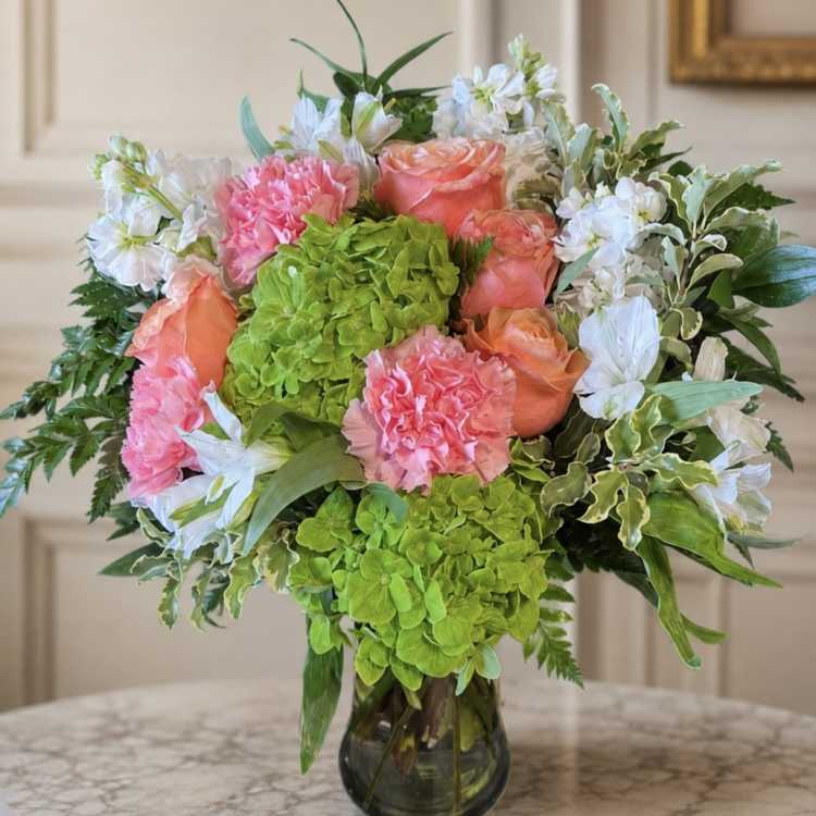 Bouquet of pink and peach flowers in a glass vase