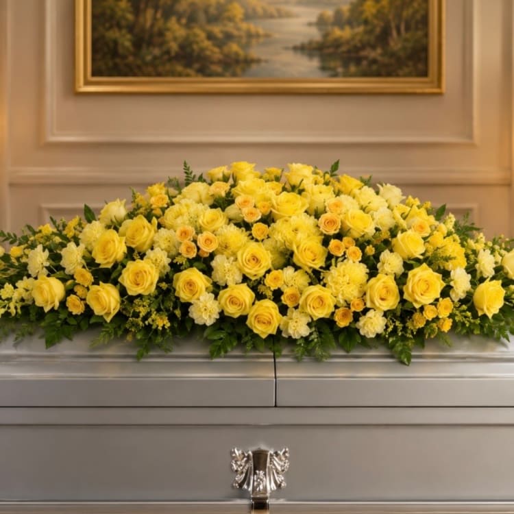 Yellow rose casket spray with white accent flowers