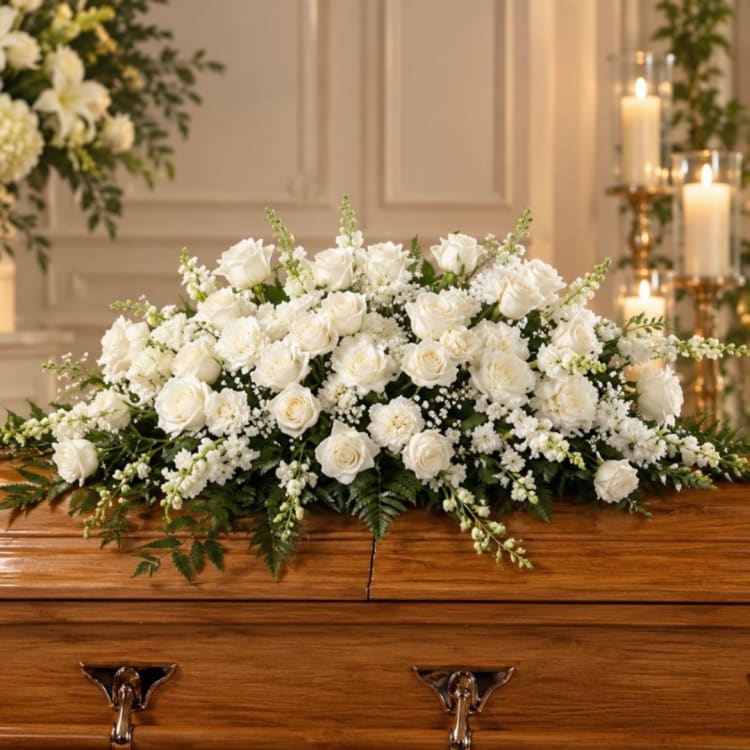 White rose and chrysanthemum casket spray with greenery