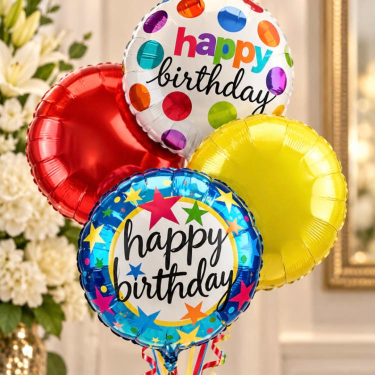 Cluster of colorful happy birthday balloons in front of flowers