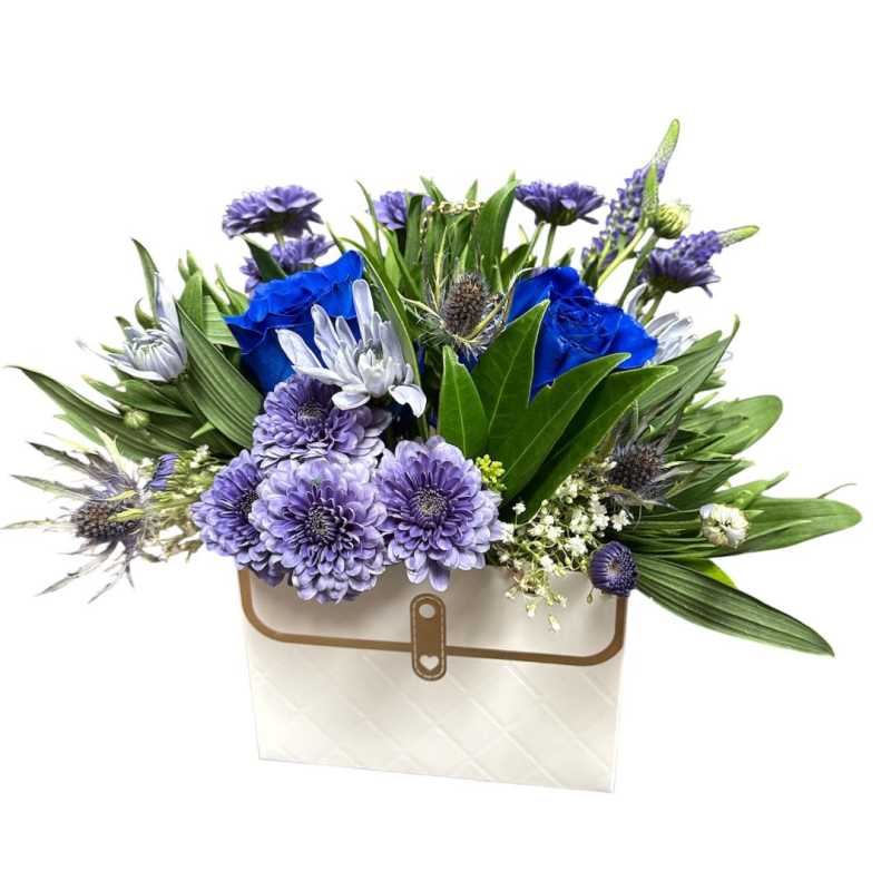 Blue and lavender flower arrangement in a white gift box
