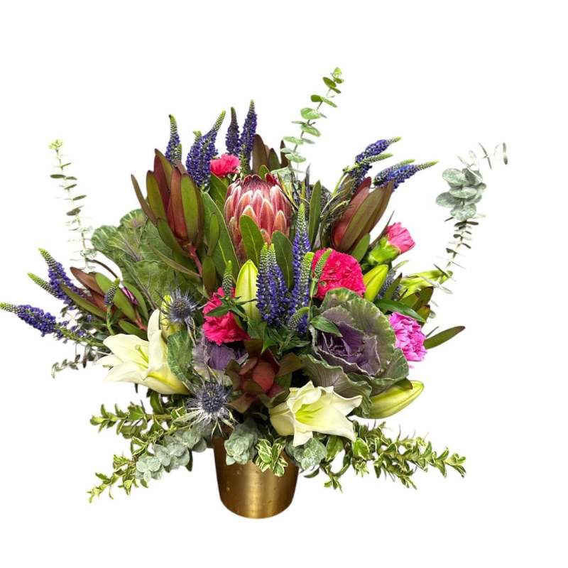 Mixed bouquet with purple, pink, and white flowers in a gold vase
