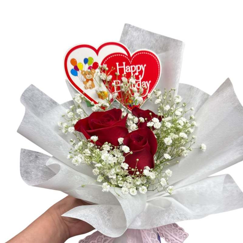 Red roses with baby's breath and a Happy Birthday heart topper