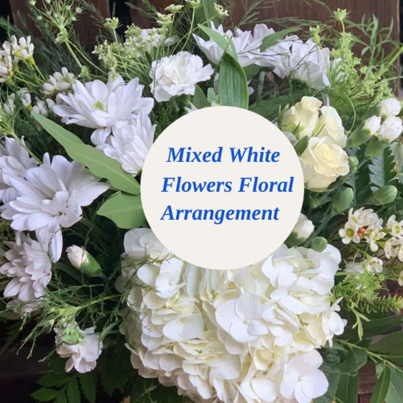 Mixed white floral arrangement with daisies, roses, and hydrangeas