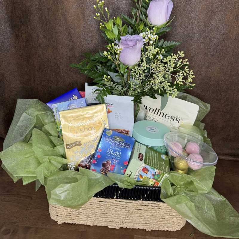 Lavender roses in a gift basket with chocolates and tea