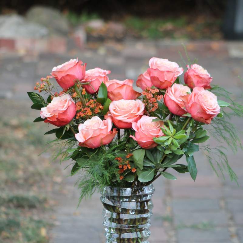Pink roses arranged in a clear glass vase