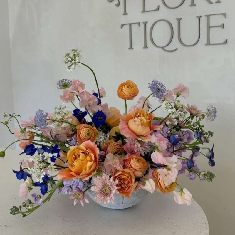 Mixed pastel bouquet in a low white vase