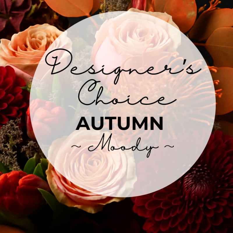Autumn floral arrangement with roses and dark red blooms