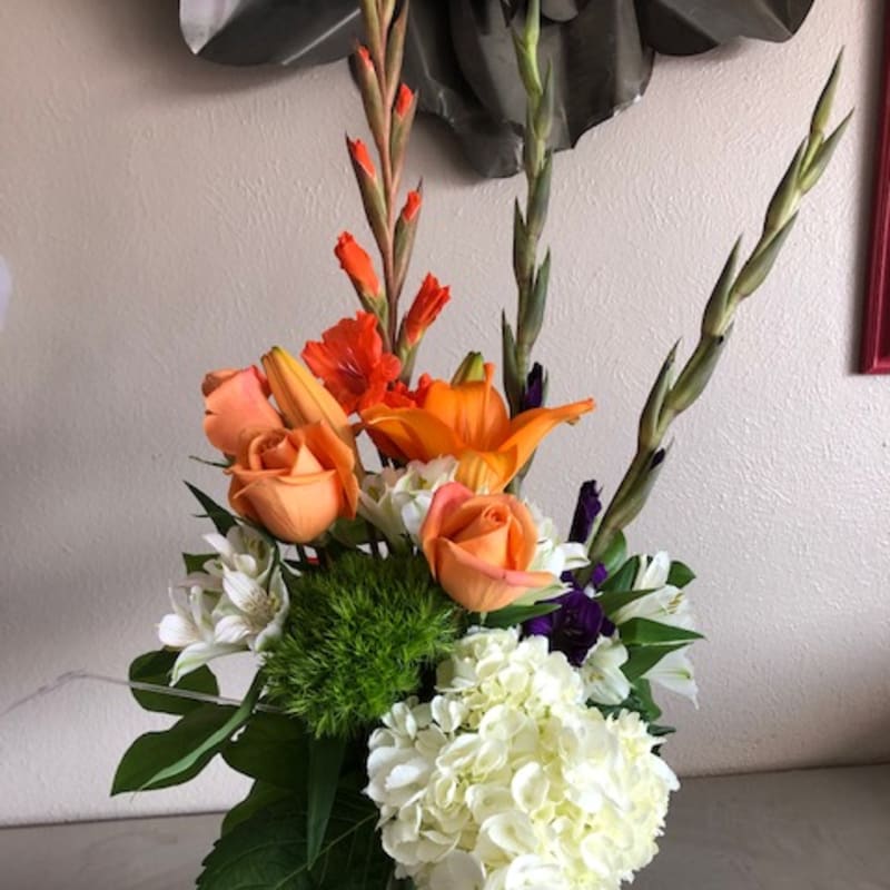 Orange roses and white hydrangea in a glass vase