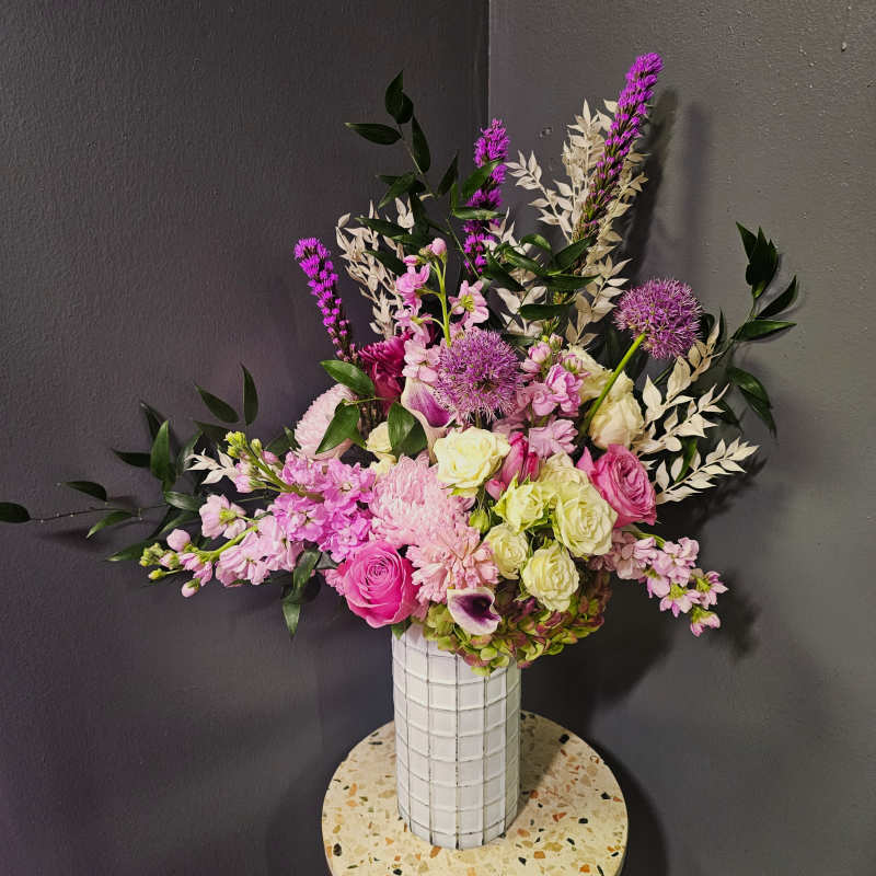 Pink and white mixed bouquet in a tall white vase
