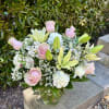 Fresh lilies and roses come together in a soft seasonal palette that