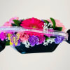 Colorful bouquet with gerbera daisies and carnations wrapped in dark paper