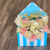 Box of cream roses, pink carnations, and small daisies