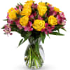 Yellow rose and pink alstroemeria bouquet arranged in a clear glass vase