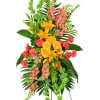 Tall standing spray with orange lilies, yellow roses, pink flowers, and green Bells of Ireland on an easel