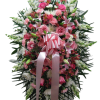 Tall standing spray with pink and white flowers and a large pink ribbon bow