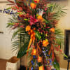 Orange roses, stock, lilies, and greenery. 